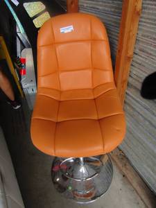 lot 19 image: Orange padded lift barber chair, very good condition swivels with adjustable height