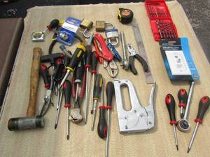 lot 176 image: tool lot includes, screw drivers, plyers, hammer, hand stapler, wrenches, sockets, tape measures and more