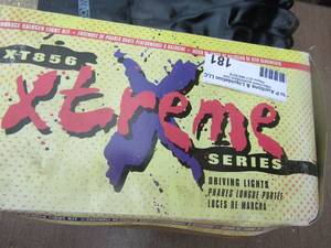 lot 181 image: Extreme series driving lights in original box-- 4 pair of black rubber gloves one size fits all