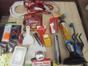 lot 201 image: Tool lot includes various items such as, power plunger, water lines, mini jumper cables , outlets, washers and more