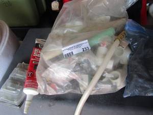 lot 233 image: Kwik seal, red dot diplex covers, bag of pvc piping elbows, large bolts