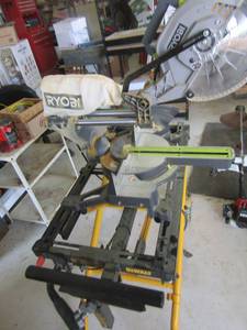 lot 2 image: Ryobi table saw on a DeWalt rolling stand