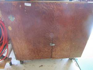 lot 11 image: wooden rolling workshop table CONTENTS NOT INCLUDED has 2 door with 2 tier shelving