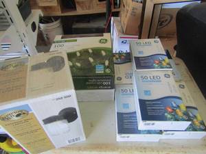 lot 16 image: 5 boxes of led indooroutdoor decoration lights colored, 2 boxes of 100 mini crystal lights and Hampton bay exterior wall lantern