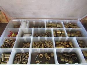 lot 66 image: small clear storage box full of various size brass connecter air hose pieces and more