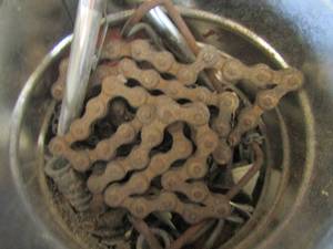 lot 70 image: large lot of caster rollerswheels, bycicle chain, various clamp and a coffee can of nails and more