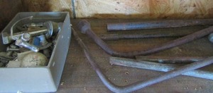 lot 71 image: various size tire tool irons and small tray of various size nuts and bolts, colking gun a crow bar and more