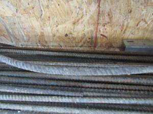 lot 203 image: Large lot of rebar unknown length, appears to be 1 thick