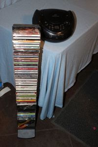 lot 170 image: CD Rack Full of CDs and a Portable StereoCD Player - See Photos