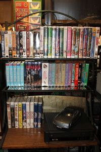 lot 193 image: Magnavox VHS Player, VHS Auto Rewinder, and Large Selection of VHS Movies