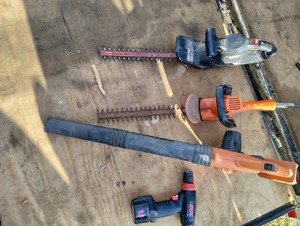 lot 38 image: Two Black and Decker Electric Bush Trimmers, Black and Decker Battery powered Blower.. no battery, and Skill Cordless drill, no Charger