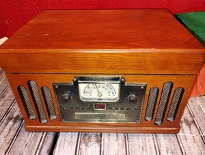 lot 34 image: Crowley Record player with cassette deck, CD player, and Radio Tuner in a vintage Look.. Included is a Jim Nabors Album How Great Thou Art&nbsp