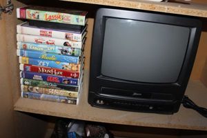 lot 81 image: Zenith TVVCR Combo and a Selection of VHS Tapes Titles as shown in photos