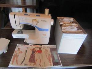 lot 10 image: brothers sewing machine and a box of simplicity patterns (helton)