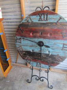 lot 14 image: Wooden dcor clock on stand clock is 36 diameter , stand is 61 inches tall,  clock hands need repair (BW 1)