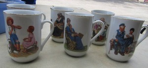lot 60 image: Set of 6 Norman Rockwall handled coffee cups with gold rim in good condition
