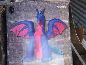 lot 125 image: Holiday living inflatable dragon- 11ft tall in original box, package has damage but not merchandise