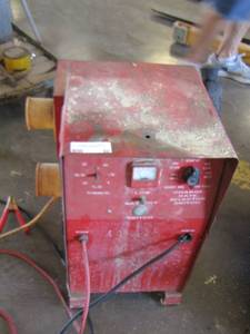 lot 50 image: Battery charger of some type, plane batteries and more