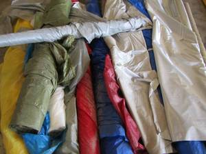 lot 92 image: rolls of plastic, cloth, fabric