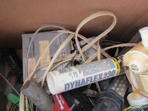 lot 99 image: Craftsman light- caulking,  cans of used spray paints- snap on battery chargers and more