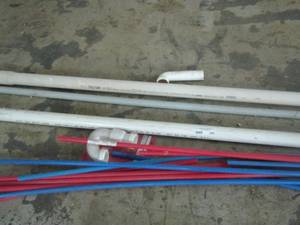 lot 240 image: red and blue pex B tubing 12 inches by 20 in long and various pieces of plc. Piping