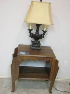 lot 11 image: SIDE TABLE WITH MAGAZINE HOLDERS ON BOTH SIDES AND A BLACK LAMP SIZE 28 INI TALL AND TABLE IS 26X27 12 X 16