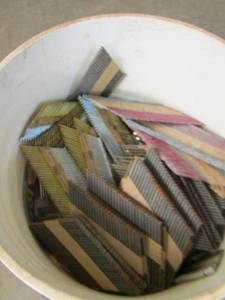 lot 57 image: BUCKET FULL OF NAIL STRIPS FOR A NAIL GUN