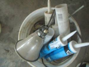 lot 236 image: tubes of silicone, caulking, and 1 hanging workshop light