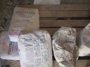 lot 258 image: various bags of tile grout poly blend, 6 boxes of glazed ceramic tile NIB