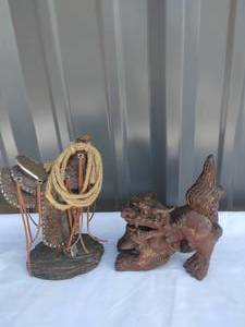lot 160 image: 2 Mantel Decor Pieces---Saddle on Stand and Hand Carved Stone Dragon