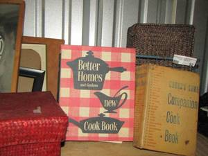 lot 92 image: compassion cook book, better homes cook book, green metal basket and brown and red wicker basket with lid