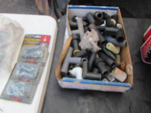 lot 49 image: peg board hooks, black pvc pipe pieces, unknown use