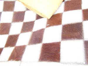 lot 77 image: COW HIDE Checker board- fluffy throw blanket