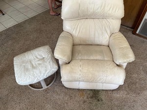lot 15 image: Lazy boy recliner well used with a white padded foot stool