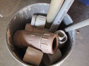 lot 223 image: bucket of various plc. Piping pieces