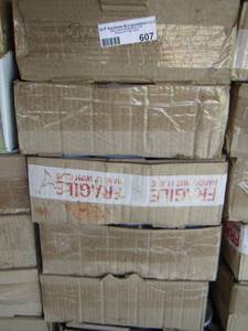 lot 607 image: 9 flat boxes of funny coffee cups with 12 per box