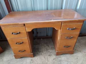 lot 92 image: Vintage Solid Wood 7 drawer desk with iron pulls.  45 12x30x20 12  Unable to decipher maker