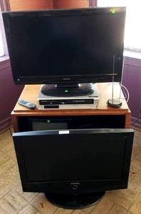 lot 310 image: Samsung, Emerson, Sylvania, Sharp TVs and electronics plus TV stand as shown