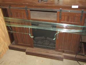 lot 1 image: TV stand fire place insert, has sliding barn front doors - 355415 great condition