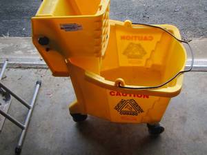 lot 65 image: new yellow industrial mop bucket, mop not included