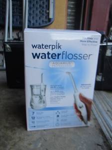 lot 77 image: Waterpik water flosser opened in original box