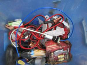 lot 133 image: Blue tote misc. tools- plunger- air hose knobs- jumper cables