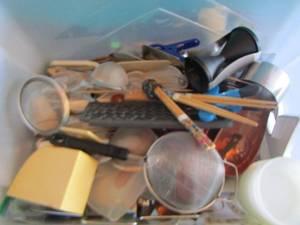 lot 209 image: Medium tote of kitchen utensils- 2 pan lids- food scale strainer and more