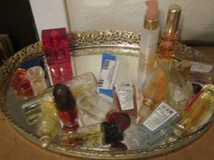 lot 183 image: glass tray with new and used bottles of perfume and hand sanitizer
