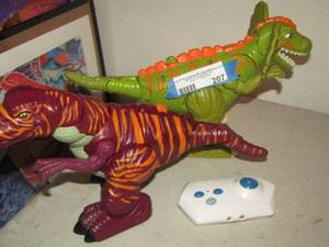 lot 207 image: 2 toy dinosaurs with a white controller