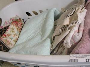 lot 272 image: towels, pillowcases, and misc. sheets in white basket