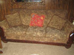 lot 12 image: Full size solid wood brown couch with various throw pillows