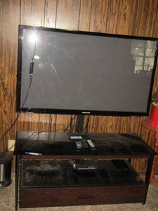 lot 60 image: 42 TV on TV stand glass top, 2 tier- one single drawer at the bottom- 204618