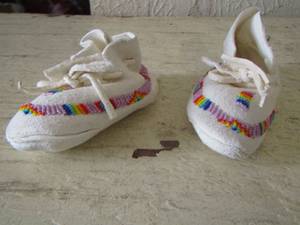 lot 14 image: Native American hand made white leather baby shoes beaded - were a gift to family