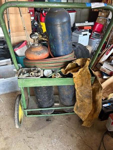 lot 172 image: Welders tanks and hoses w cutting tip,  on rolling stand , protective gear